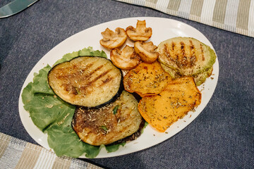 grilled mushrooms, eggplant, zucchini and bell peppers on a plate. 