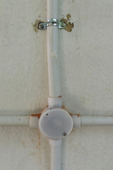 plastic pipe and four angle side pipe attached on the wall