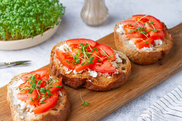 Bruschetta with tomato and watercress close-up