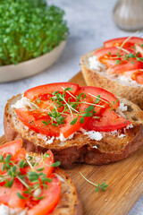Watercress with tomato on bruschetta, close-up