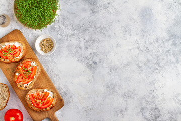 Gray background with bruschettas with watercress