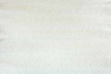 Background of light beach sand with shifted focus