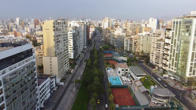 Time lapse drone video of a street in Lima, Peru. Its in the district of Miraflores and its called "Bajada Balta" Filmed descending altitude, tilting camera up. Many buildings can be seen in horizon.