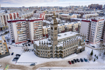 Surgut city in winter. Residential area, foreign language school - Big Ben. Aerial view.