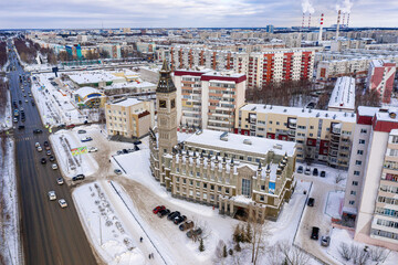 Surgut city in winter. Residential area, foreign language school - Big Ben. Aerial view.