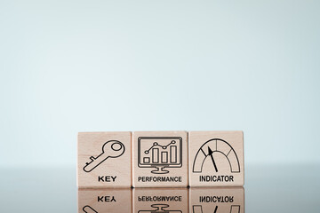 Key Performance Indicator(KPI) use for business concept,key,performance,indicator icon on wooden cube over white background with copyspace.