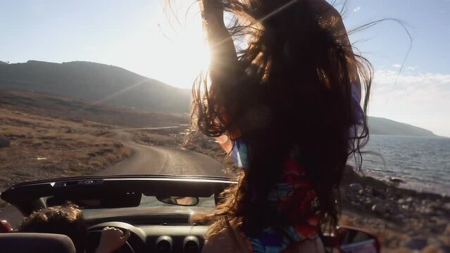 Sporty girl standing in cabriolet. Best friends spend summer time together and girls enjoy life. woman road by car to sea. Friendship and love forever, Concept of Lifesyle people, travel and beauty of