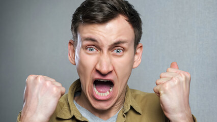 Close up of angry man screaming. The expression of a person's anger. Threat of violence.