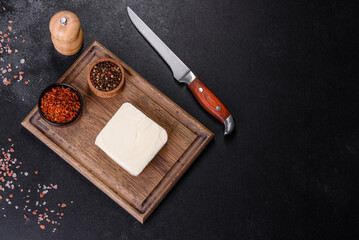 Image of a bar and grated mozzarella cheese on a dark background