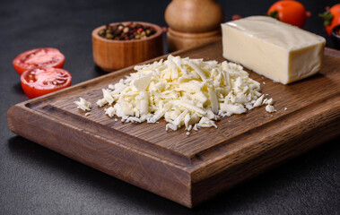 Image of a bar and grated mozzarella cheese on a dark background