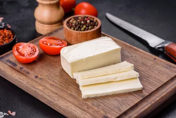 Foto op Plexiglas Image of a bar and grated mozzarella cheese on a dark background © chernikovatv