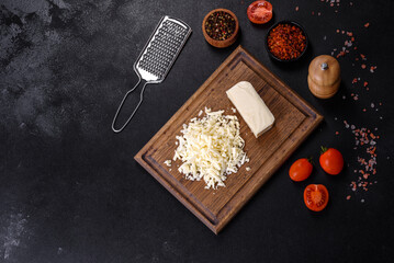 Image of a bar and grated mozzarella cheese on a dark background