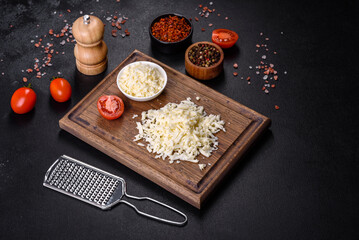 Image of a bar and grated mozzarella cheese on a dark background