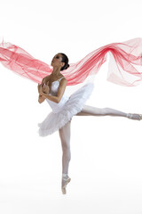 Ballet Concepts. Professional Japanese Female Ballet Dancer Posing in White Tutu With Red Veil in Lifted Hands Against White Background.