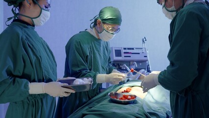 Medical surgical doctor team performing surgery patient, Group surgeon at work on operating room...