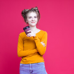 Beautiful Caucasian Girl With Paper Disposable Cup Posing WIth Smile and Drink Against Seamless Coral Pink Background.