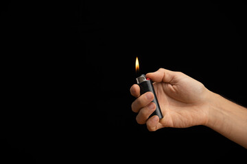 hand of a man handing a lit lighter - Powered by Adobe