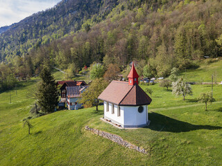 Fototapeta na wymiar Aerial image of the little chapel at Betlis hill side over the Walensee Lake in Switzerland