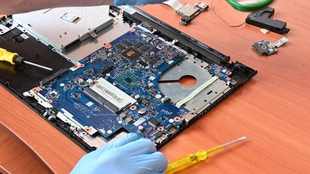 laptop repair. master repairs a disassembled laptop. professional printed circuit board(PCB) repair. fault detection.