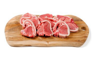 Fresh lamb chops on wooden cutting board and white background. Meat industry product. Butcher craft.
