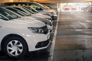 Row of cars in a car park or dealership. Selective focus. Busy parking lot on town or shopping...