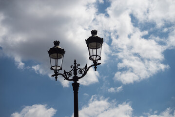 Fototapeta na wymiar Closeup of vintage street light on beautiful cloudy sky background