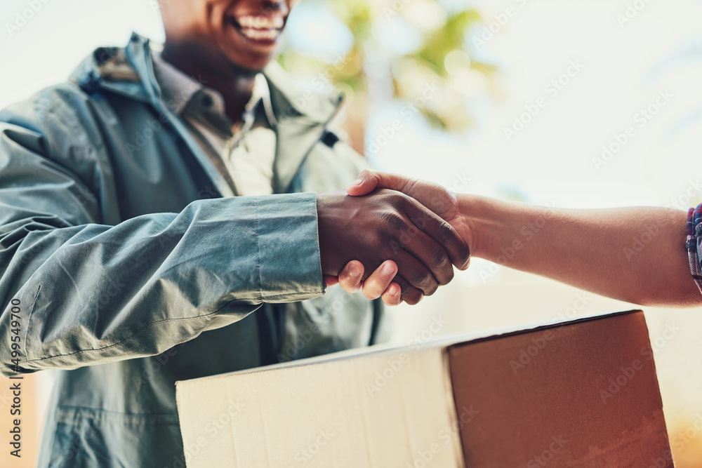 Poster excellent service goes a long way. closeup shot of a courier shaking hands with a customer while mak
