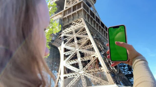 Teenage girl with loose hair brown hair brown hair dances with phone rejoices on the screen of lameness green screen beige background. High quality 4k footage
