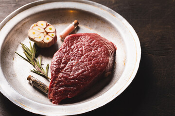 Fresh meat top view. Raw beef steak and spices for cooking.