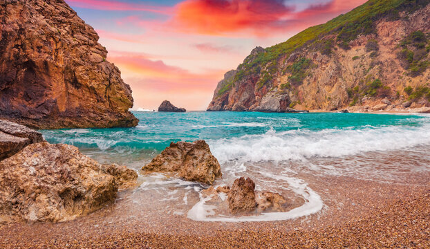 Colorful summer view of Gyali beach. Splendid morning seascape of Ionian Sea. Amazing sunrise on Corfu island, Greece, Europe. Vacation concept background..