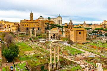 Fototapeta na wymiar December 4, 2022 - Rome, Italy: Panoramic view over Forum Romanum with Temple of Saturn, arches and columns remains.