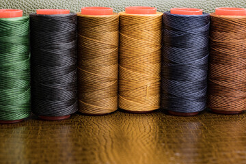 spools of colored thread stand on the skin