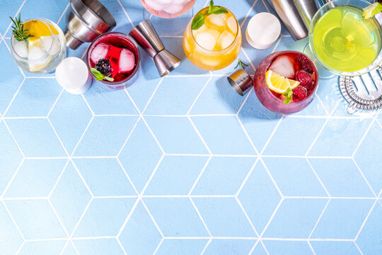 Summer bar cocktails menu. Set of different glasses variations of drinks, mocktails, cocktails, sparkling refreshing beach water. Citrus and fruit drinks with garnish and ice cubes copy space