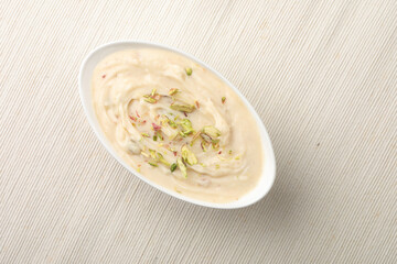 Shrikhand is an Indian sweet dish made of strained curd,garnished with dry fruits and saffron....