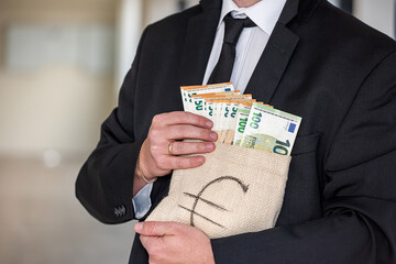 young official in a stylish suit holds a bag with looted euros.