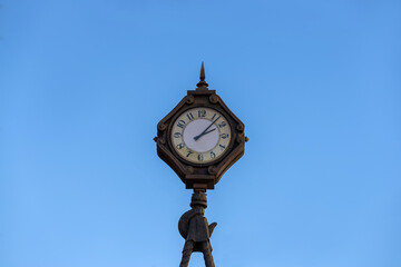Fototapeta na wymiar Old clock against the background of the blue sky