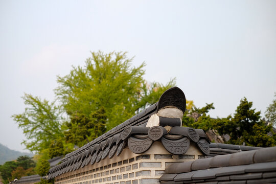 Korean palace stone wall fence of korean traditional village house on natural sky background in South Korea.