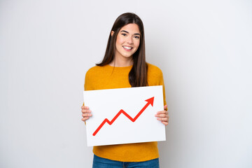 Young Brazilian woman isolated on white background holding a sign with a growing statistics arrow symbol with happy expression