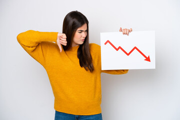 Young Brazilian woman isolated on white background holding a sign with a decreasing statistics arrow symbol and doing bad signal