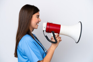 Young Brazilian nurse woman isolated on white background shouting through a megaphone