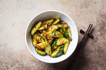 Chinese smashed cucumber salad with chili peppers and sesame seeds, copy space.