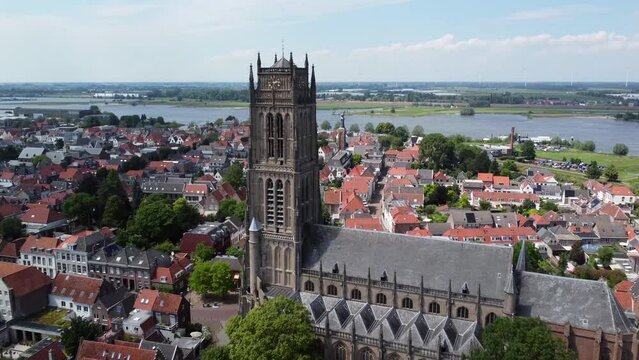 Aerial drone footage of the Saint Martin church in Zaltbommel is a municipality and a city in the Netherlands in the background showing Waal river a branch of the river Rhine 4k high resolution