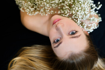 Young woman with a bouquet of small flowers.