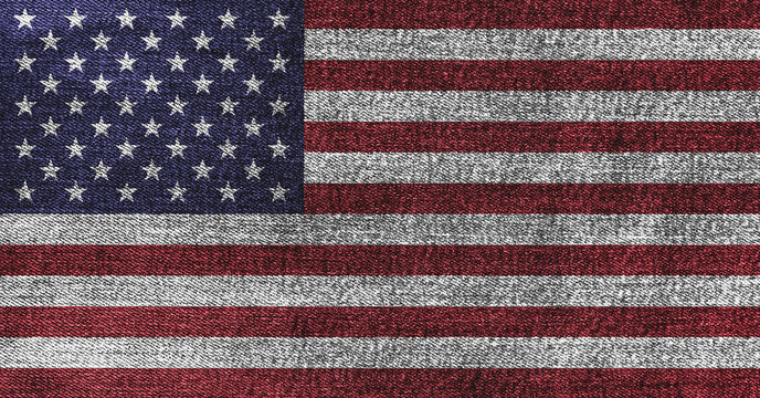 Grunge American flag on denim jeans textured abstract background concept. The National USA flag on denim frabric texture.