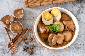 Top view stewed eggs and pork belly in black sweet sauce, traditional and popular Thai food.