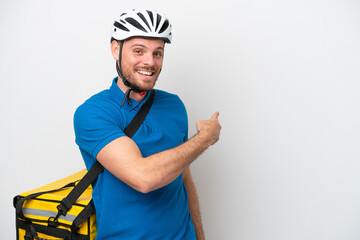 Young brazilian man with thermal backpack isolated on white background pointing back
