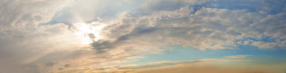 Naklejka na ściany i meble Panorama of sky clouds background with sunlight