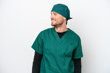 Surgeon Brazilian man in green uniform isolated on white background looking side