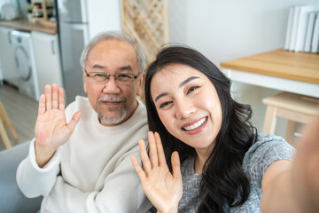 Asian lovely family, young daughter use phone selfie with older father