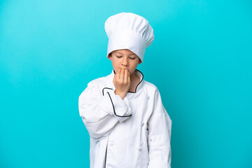Little chef boy isolated on blue background having doubts